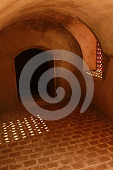 A aged hall view with sun light through in window of the Manora fort.