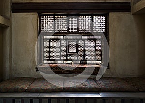 Aged interleaved wooden window and a built-in couch