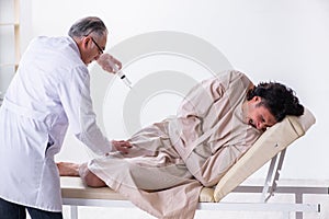 The the aged male doctor psychiatrist examining young patient