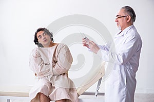 Aged male doctor psychiatrist examining young patient