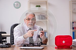 Aged male employee suffering at workplace