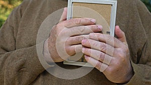 Aged male hugging photo missing children, sad widower remembering wife nostalgia