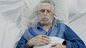 Aged male loudly snoring and puffing in bed, sleeping problems at old age