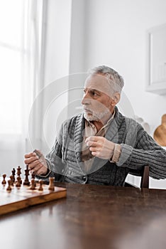 aged man with alzheimer disease holding