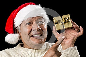 Aged Man With Emphatic Look And Golden Gift photo