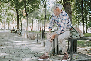 Aged man having sudden ache in his knee stock photo