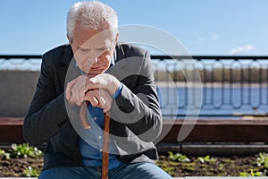 Aged man thinking about his life outdoors