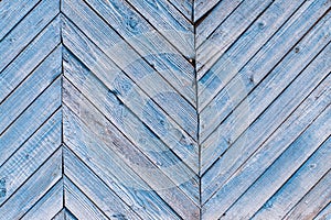 Aged painted cracked boards with blue color peeling. Old natural grunge textured wooden background. Weathered wood wall for design