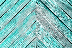 Aged painted cracked boards with turquoise color peeling. Old natural grunge textured wooden background. Weathered wood wall for