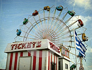 Aged photo of carnival ride and ticket booth