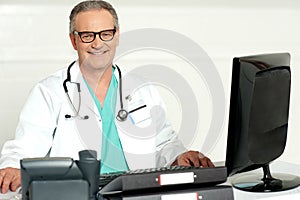 Aged physician with stethoscope around his neck