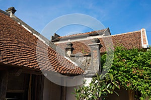 Aged red tiled rooftop in Duong Lam ancient village, Hanoi, Vietnam