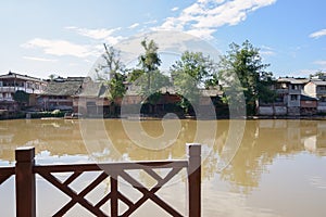 Aged riverside dwelling buildings in sunny autumn