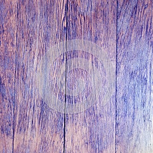 Aged rustic wooden background texture in violet color