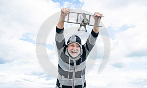 aged senior man on sky background. senior man at retirement. senior retired man with toy plane