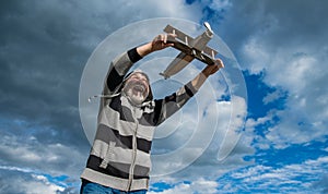 aged senior retired man. mature man at retirement. old man on sky background with toy plane outdoor