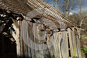 Aged shed with a wooden roof