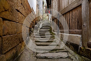 Aged stone stairway between ancient houses at Luoquan town