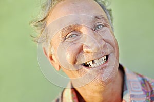 Aged toothless man smiling at camera