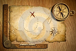 Aged treasure map, ruler and old brass compass