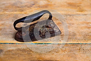 Aged vintage clothes iron in rusted metal