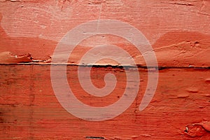 Aged weathered wood painted in red orange color