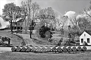 Aged whiskey, scotch, bourbon barrels in Kentucky ready for transportation in black and white