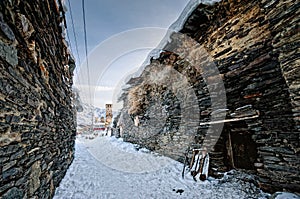 Aged winter alley in Ushguli