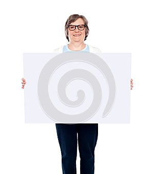 Aged woman displaying blank poster photo