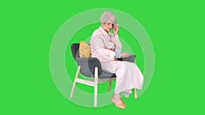 Aged woman measuring blood pressure Reaction on a high or low pressure on a Green Screen, Chroma Key.