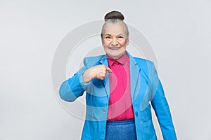 Aged woman pointing finger herself and toothy smiling