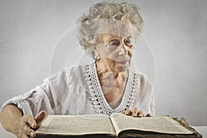 Aged woman reading a book