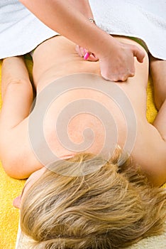 Aged woman relaxing at spa massage