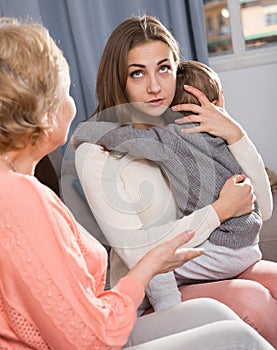 Aged woman is sharing her experience with daughter for upbringing toddler
