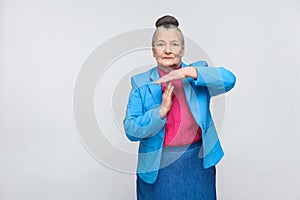 Aged woman showing time out sign