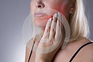 Aged woman with toothache, teeth pain closeup photo