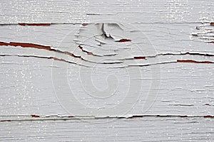 Aged wooden background of board with cracked and peeling gray paint. Copy space.