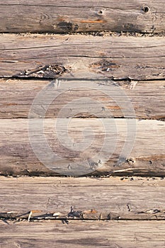 Aged wooden log wall with cracked surface