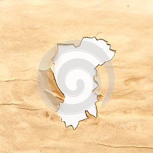 Aged wrinkled beige paper burnt hole grunge design