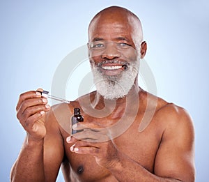 Ageing is unkind. Studio portrait of a mature man applying serum to his face against a blue background.