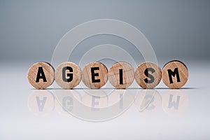 Ageism Text On Round Blocks Over White Desk