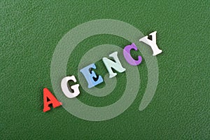 AGENCY word on green background composed from colorful abc alphabet block wooden letters, copy space for ad text. Learning english