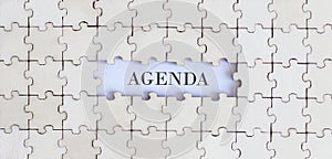 AGENDA .Business concept. White puzzle pieces with different phrases on white background