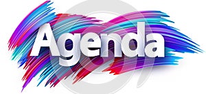 Agenda paper word sign with colorful spectrum paint brush strokes over white