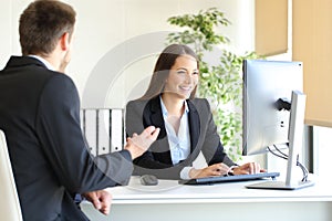 Agent attending a client at office photo