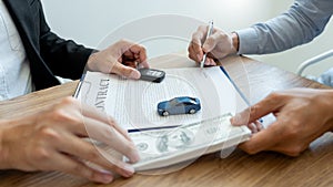 Agent broker man holding document showing an transportation contract form to client ownership  customer and salesman with car key