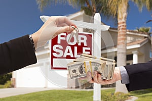 Agent Handing Over Keys, Buyer Handing Over Cash for House