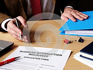 Agent offers business interruption insurance application papers