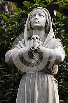 Agentina, virgin mary praying dwelling to heaven marble sculpture in lourdes sanctuary of the city of mar del plata