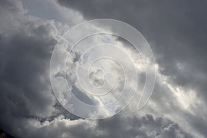 Agglomerations of clouds torn by the rays of the sun